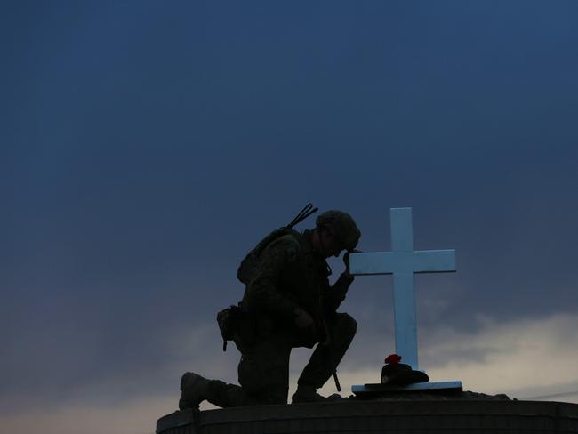 Lance Corporal Patrick Carr of 8/9 RAR pays his respects to Australia's fallen diggers from Gallipoli to the bloody fields of Afghanistan in Taji in Iraq / Picture: Gary Ramage