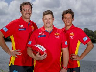 New Gold Coast Suns players Brayden Crossley, Suns coach Stuart Dew and Wil Powell.  Picture: Jerad Williams