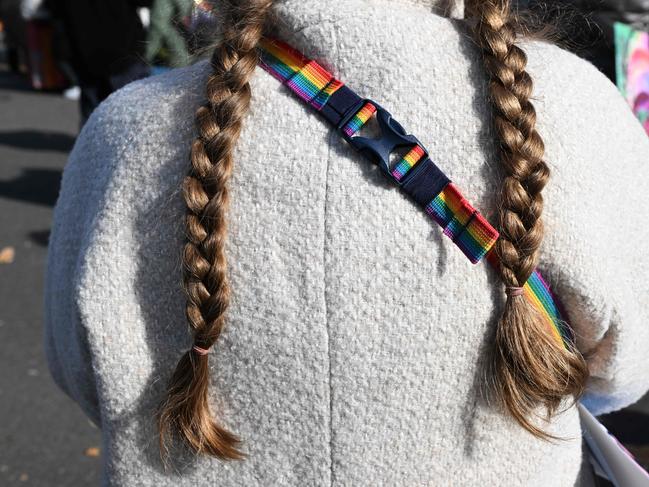 A supporter of the LGBTQ+ community stands outside the US Supreme Court on December 4, 2024 in Washington, DC, during oral argument on whether states can ban certain gender transition medical treatments for young people. The case was brought by three transgender teens, their parents and a doctor who are seeking to ensure health-care access they say is critical. (Photo by ROBERTO SCHMIDT / AFP)