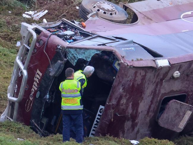 MELBOURNE, AUSTRALIA- SEPTEMBER 21 A school bus carrying 32 people has flipped on the Western Highway in Bacchus Marsh. Police are investigating the crash between a school bus and a truck that occured at around 3.15am. Picture: Brendan Beckett