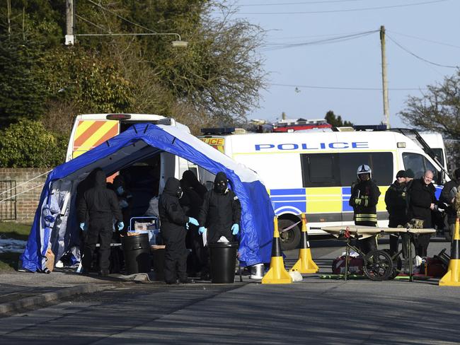 Various police, Army and other emergency service personal attend a scene in Durrington near Salisbury, England, as a car is taken away for further investigation into the suspected nerve agent attack. Picture: AP