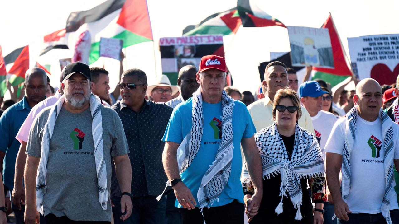 Cuba’s Prime Minister Manuel Marrero, Cuba’s President Miguel Diaz-Canel, and his wife Lis Cuesta take part in a march in support of the Palestinian people. Picture: AFP