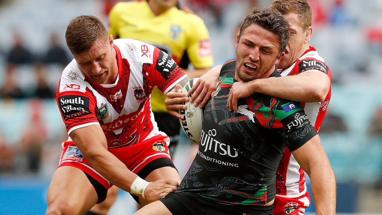 Sam Burgess of the Rabbitohs is tackled by Tariq Sims and Cameron McInnes.