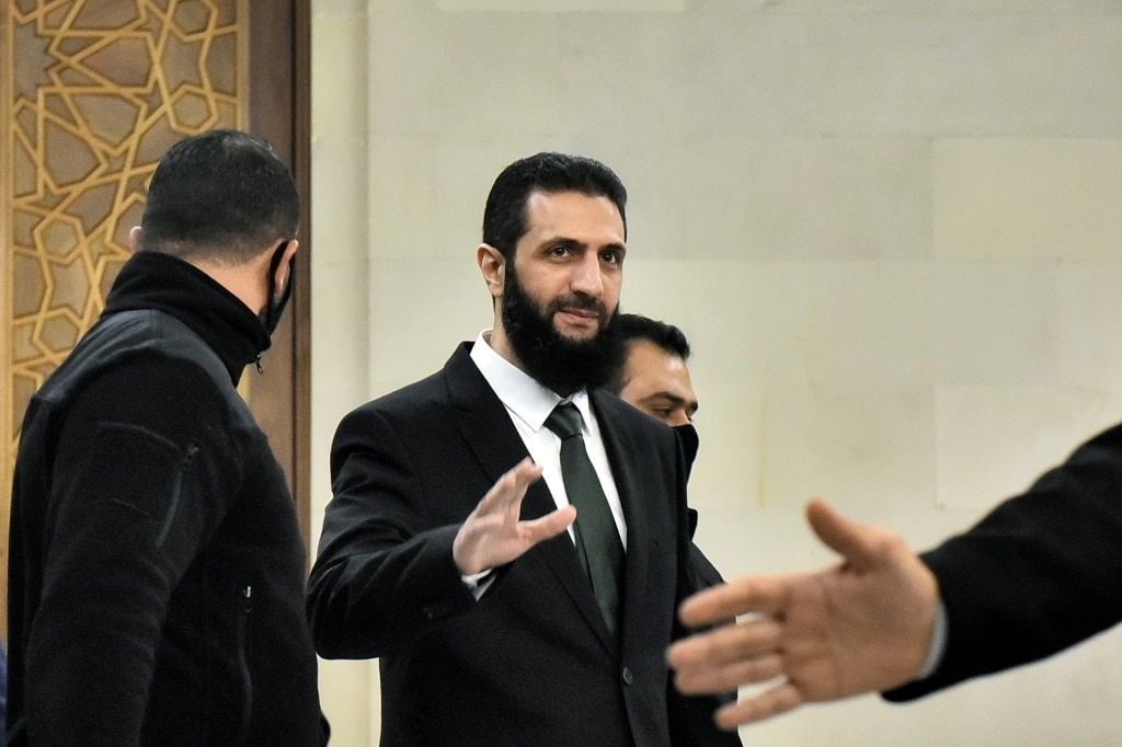 Syria's new leader Ahmed al-Sharaa has traded in the olive-green military shirt he sported just days ago for a suit and tie