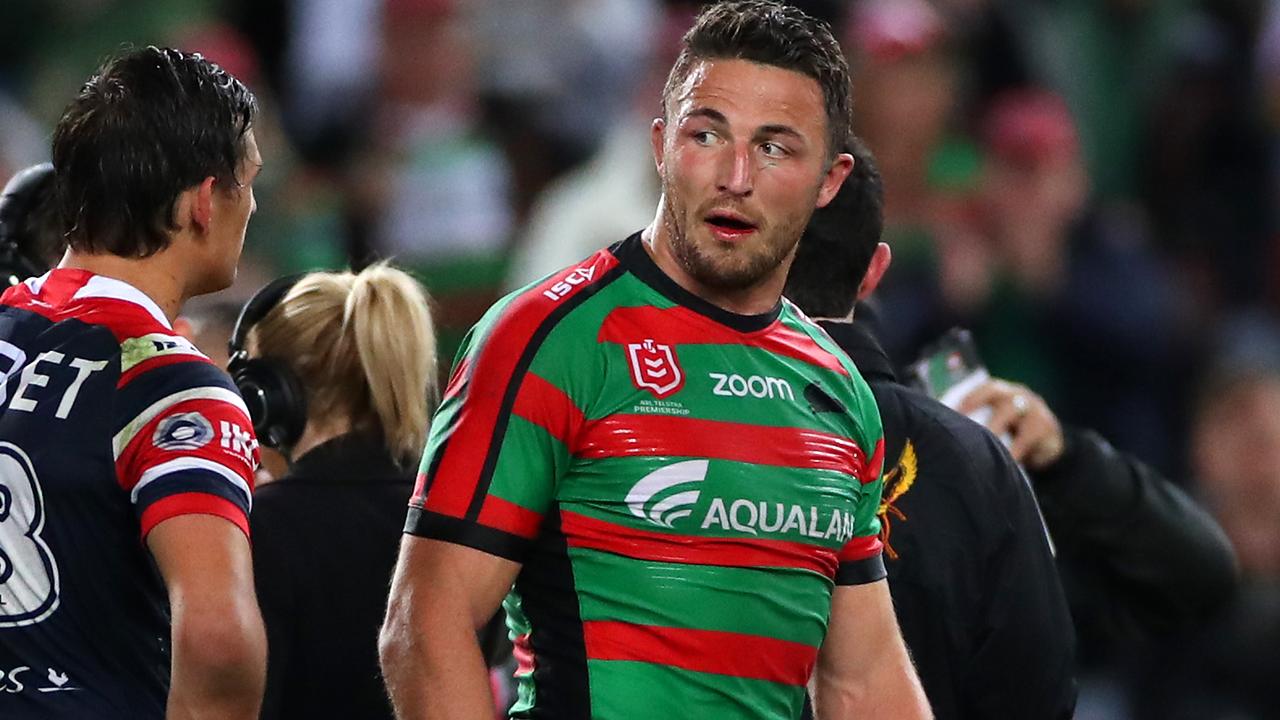 Sam Burgess of the Rabbitohs exchanges words with Billy Smith of the Roosters