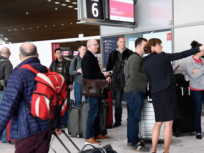 Airport staff help travellers in Paris after President Trump imposed a shock travel ban to begin on Friday. Picture: Bertrand GUAY / AFP.