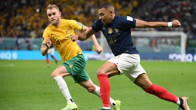 Australia's midfielder #03 Nathaniel Atkinson (L) fights for the ball with France's forward #10 Kylian Mbappe during the Qatar 2022 World Cup Group D football match between France and Australia at the Al-Janoub Stadium in Al-Wakrah, south of Doha on November 22, 2022. (Photo by FRANCK FIFE / AFP)