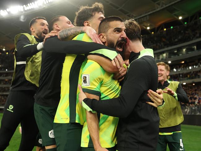 Aziz Behich is mobbed by his Socceroos teammates. Picture: Getty Images