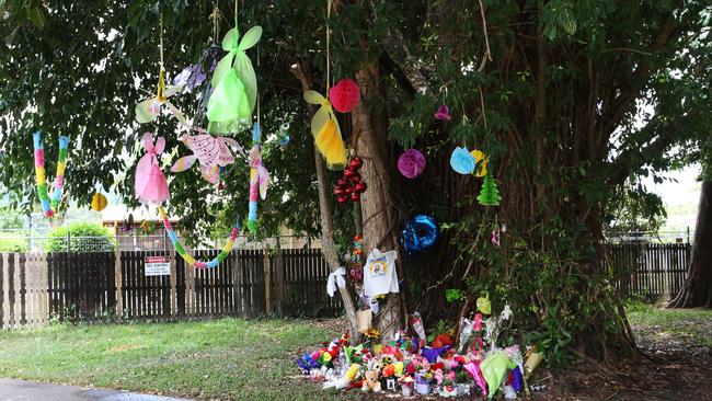 Floral tributes left at a temporary memorial in Murray Street park, Manoora, adjacent to where eight children were stabbed to death two weeks after the tragedy. Picture: Brendan Radke.