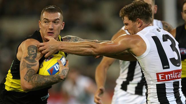 Dustin Martin gets rid of Magpie Taylor Adams in Round 2. Picture: Wayne Ludbey