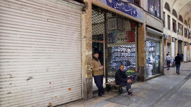 Iranian vendors sit outside as other shops are closed in Tehran’s grand bazaar. Picture: AFP