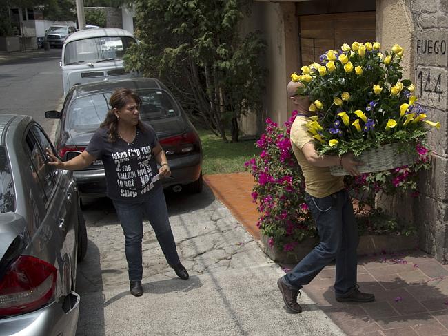 Beloved author ... a man arrives with flowers to the home of Gabriel Garcia Marquez after he left hospital on April 8, 2014.