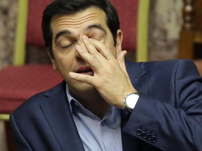 Greece's Prime Minister Alexis Tsipras reacts during an emergency parliament session in Athens, Thursday, July 23, 2015. Greek lawmakers held a whirlwind debate into the early hours Thursday on further reforms demanded by international creditors in return for a third multi-billion-euro bailout, with attention focusing on government rebels who oppose the measures. (AP Photo/Thanassis Stavrakis)