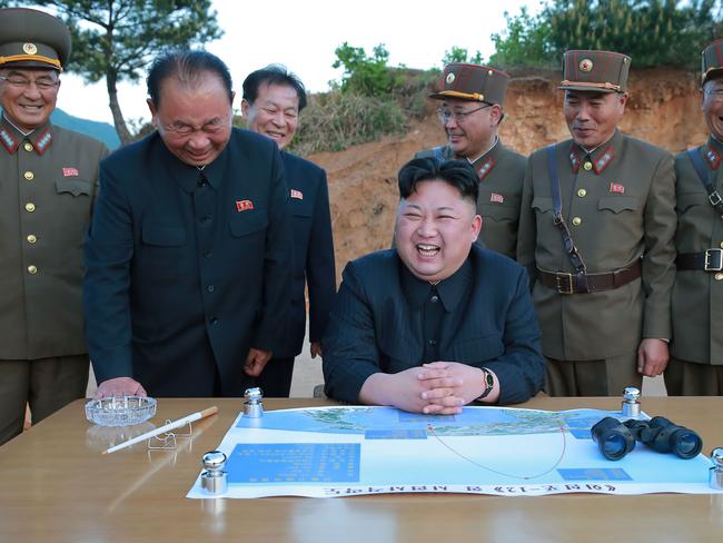 North Korean leader Kim Jong-Un reacting during a test launch of a ground-to-ground medium long-range strategic ballistic rocket Hwasong-12 at an undisclosed location. Picture: AFP