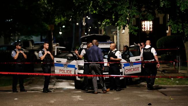 Police officers investigate the scene of a shooting in Chicago, in which 14 people were wounded. Picture: AFP