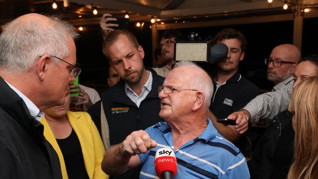 Scott Morrison is confronted by an angry pensioner during a visit to the Edgeworth Tavern in Newcastle. Picture: Damian Shaw