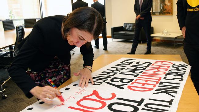 Premier Gladys Berejiklian signing the document. Picture: Virginia Young