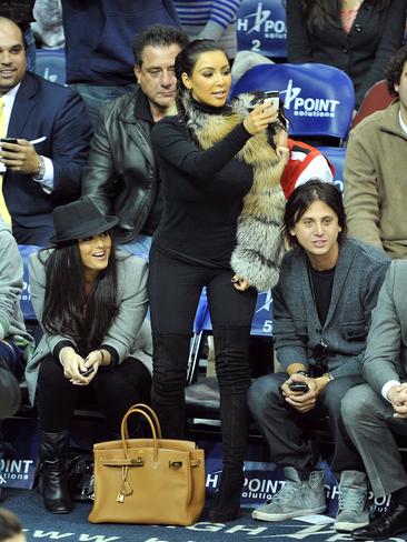 The same fan manages to score himself seats directly behind Kim Kardashian again! Kim’s BFF Jonathan Cheban and guest attend the Miami Heat vs. NJ Nets Game in New York City. Picture: Getty