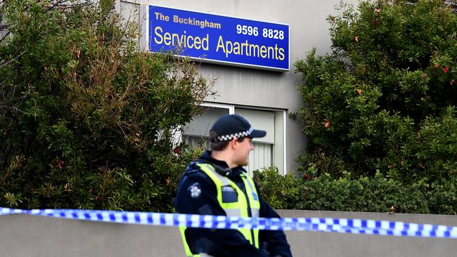 A police officer standing guard outside the Buckingham Serviced Apartments in Brighton. Picture: AAP Image/Julian Smith