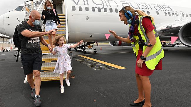 Virgin customer service agent Michaela Curtis greets passengers as they disembark their flight from Sydney at the Sunshine Coast Airport on Sunday. Picture: Lyndon Mechielsen