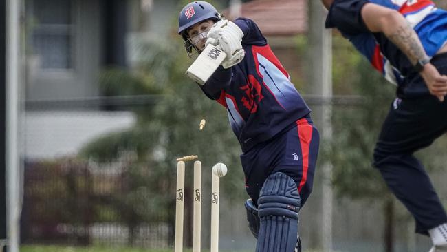 Dandenong’s Brett Forsyth is clean bowled. Picture: Valeriu Campan