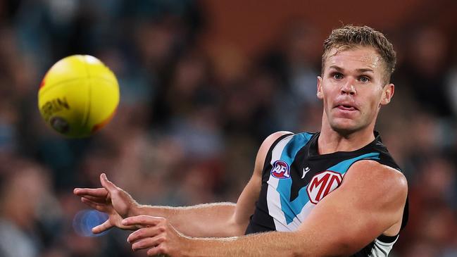 ADELAIDE, AUSTRALIA - APRIL 13: Dan Houston of the Power kicks the ball during the 2024 AFL Round 05 match between the Port Adelaide Power and the Fremantle Dockers at Adelaide Oval on April 13, 2024 in Adelaide, Australia. (Photo by James Elsby/AFL Photos via Getty Images)