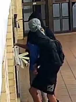 Youths pictures breaking into the Black Lime Cafe in Carrara.