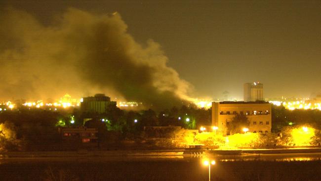 Smoke rises from one of President Saddam Hussein's palaces along the Tigris River in Baghdad after air strikes in 2003.