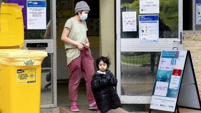 A woman and her daughter leave a testing site in Carlton on Sunday. Picture: NCA NewsWire/David Geraghty