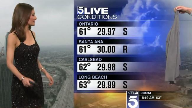 The cardigan is handed to Chan while live on air. Picture: KTLA