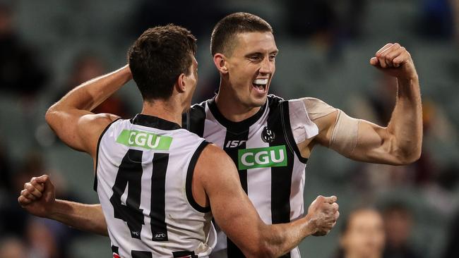 ADELAIDE, AUSTRALIA - AUGUST 11: Darcy Cameron of the Magpies celebrates a goal with team mate Brody Mihocek during the 2020 AFL Round 11 match between the Adelaide Crows and the Collingwood Magpies at Adelaide Oval on August 11, 2020 in Adelaide, Australia. (Photo by Matt Turner/AFL Photos via Getty Images)