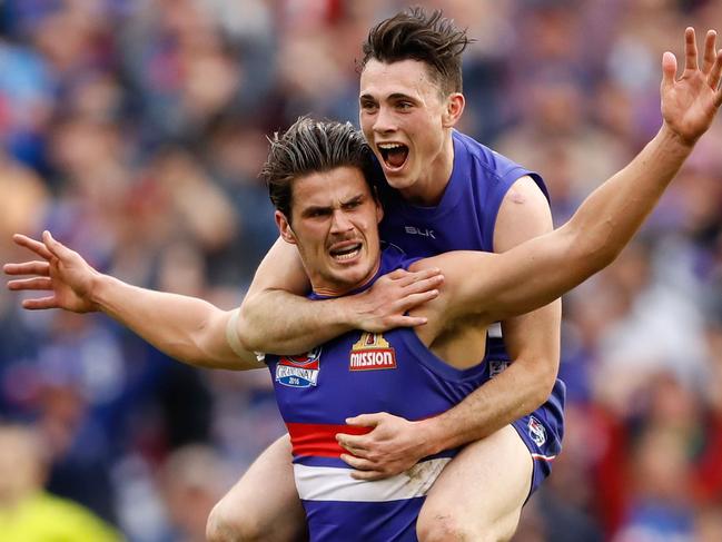 Tom Boyd, saddled by Toby McLean, celebrates the goal that clinched the 2016 grand final win. Picture: Adam Trafford/AFL Media/Getty Images