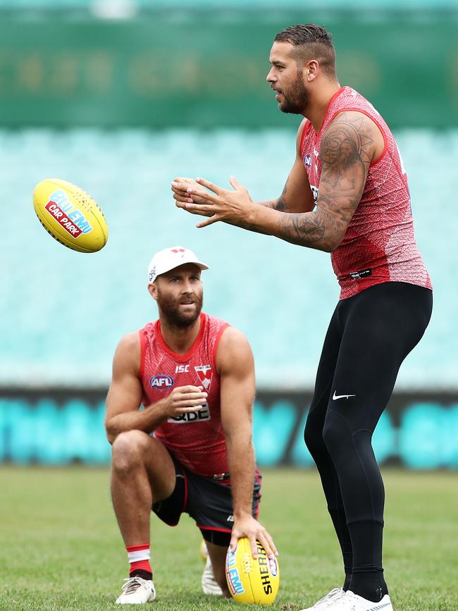 Jarrad McVeigh watches on as Lance Franklin presses his case for Round 1 at Sydney training. 