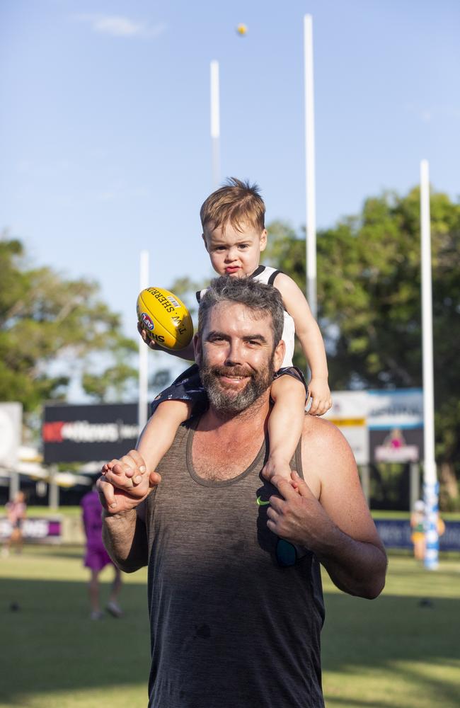 Father and son Aaron and Isaac Beaumont enjoy the NTFL prelim finals on Saturday afternoon. Picture: Floss Adams.