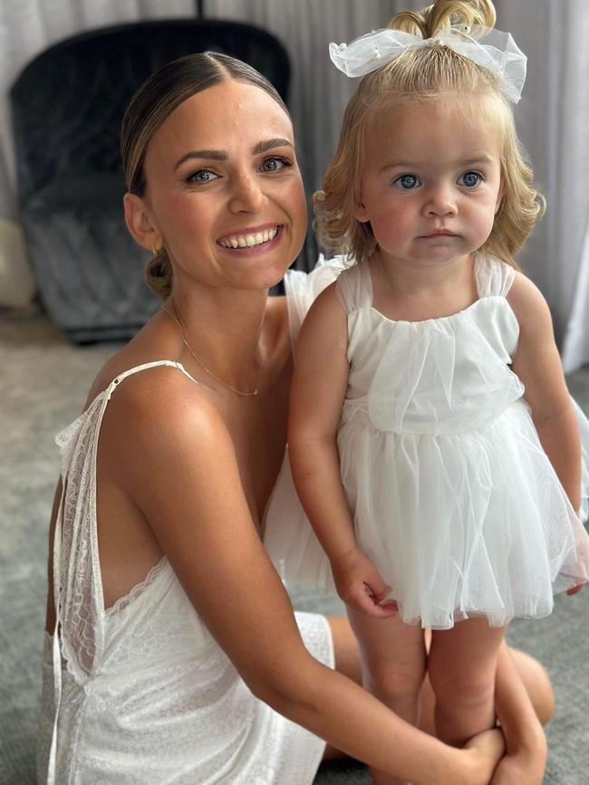 Port Adelaide star Jeremy Finlayson and his wife Kellie Finlayson were married at Tennyson Beach, South Australia. Kellie pictured with their daughter Sophia. Picture: @coilhairstudio