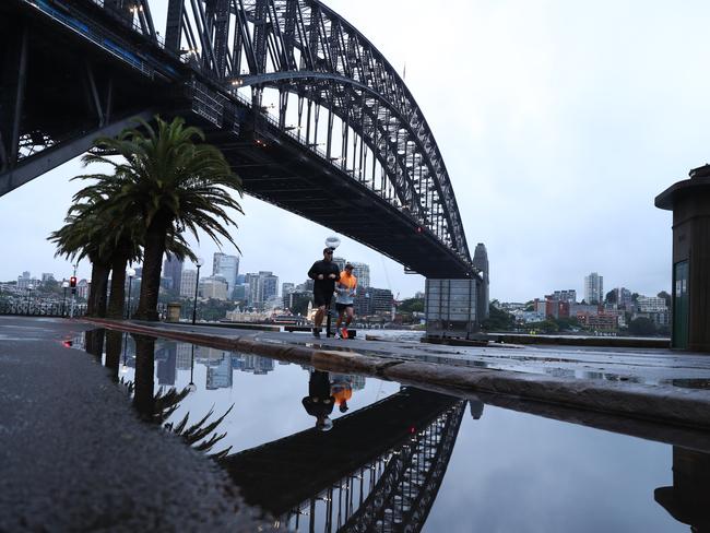 Daily Telegraph February 25/22. Wet Wet Wet . The sun pokes through a hole in the gloom over the Opera House on a soaked Friday .picture John Grainger