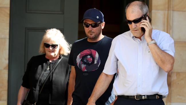 Alex Ross Gill (centre) leaves the Magistrates court with his parents. Picture: AAP / Kelly Barnes