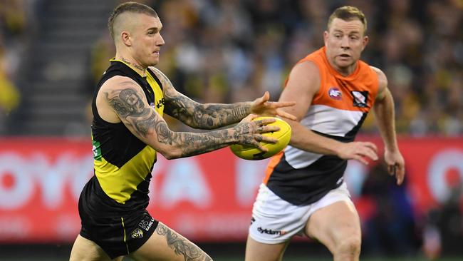 Dustin Martin kicks Richmond into attack as Steve Johnson chases.