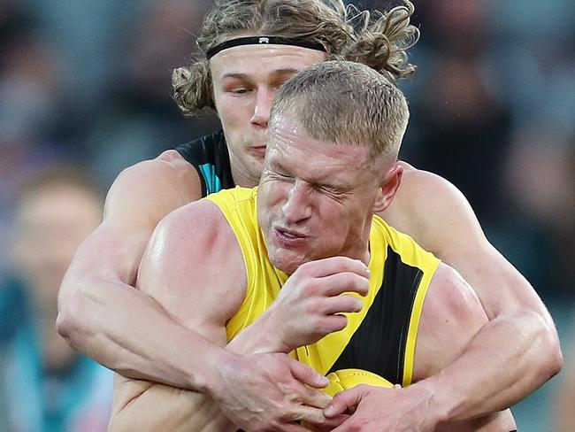 Xavier Duursma crunches Tiger Josh Caddy in Round 11. Picture: Sarah Reed