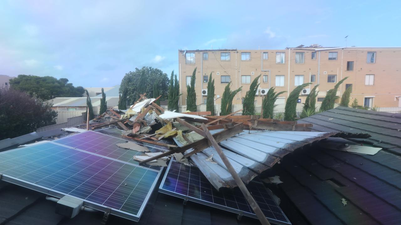 The remains of the roof from the apartment building, on top of another building. Picture: AAP / Russell Millard<br/>