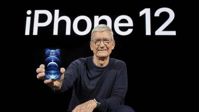 Apple CEO Tim Cook holds up an iPhone 12 Pro at the company’s launch event. Picture: AFP.