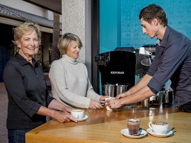 The Long Leaf Cafe at Hope Island are currently handing out free coffees ahead of their official launch in a couple of weeks. Betty Quinn and Sue Matheson receiving coffees from barista James Babington. Picture: Jerad Williams