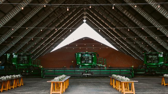 The machinery lines the wall of the grain shred for Hollie and Jono Armstrong's stunning outback wedding in Comet, Queensland. Pictures: Edwina Robertson Photography