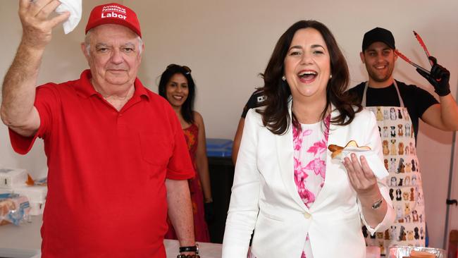 Annastacia Palaszczuk and her father Henry Palaszczuk enjoy a Democracy Sausage after she cast her vote in the 2020 state election, at Inala State School. Picture: NCA NewsWire / Dan Peled