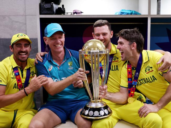 AHMEDABAD, INDIA - NOVEMBER 19: Mitchell Starc, Josh Hazlewood, Mitch Marsh and Andrew McDonald, Head Coach of Australia poses with the ICC Men's Cricket World Cup Trophy following the ICC Men's Cricket World Cup India 2023 Final between India and Australia at Narendra Modi Stadium on November 19, 2023 in Ahmedabad, India. (Photo by Robert Cianflone/Getty Images)