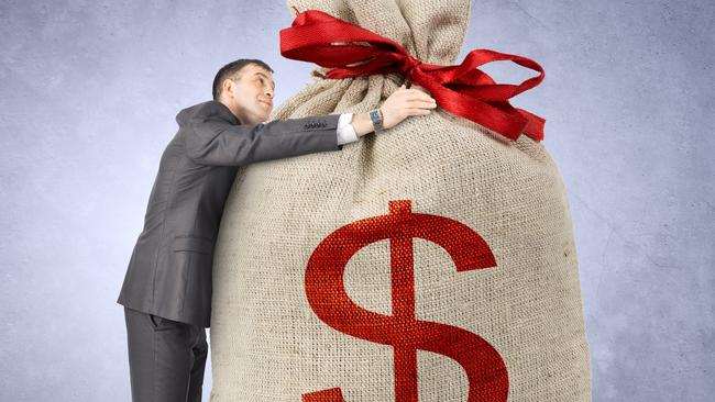 Businessman hugging bag with dollar sign on grey wall background; rich wealthy generic money