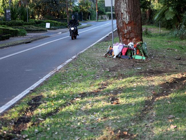 Flowers and tributes at the crash scene on Cabbage Tree Rd, Bayview. Picture: Damian Shaw