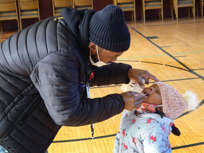 CHICAGO, ILLINOIS - NOVEMBER 12: Samuel Cravens helps his three-year-old daughter Azariah with a COVID-19 test at a test site run by CORE at St. Benedict the African Catholic Church in the Englewood neighborhood on November 12, 2020 in Chicago, Illinois. Illinois. Today Chicago Mayor Lori Lightfoot issued a stay-at-home advisory as the city topped a 14 percent positivity rate, recording nearly 2,000 new case a day.   Scott Olson/Getty Images/AFP == FOR NEWSPAPERS, INTERNET, TELCOS & TELEVISION USE ONLY ==