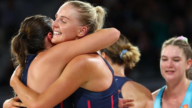 MELBOURNE, AUSTRALIA - APRIL 14: Rudi Ellis of the Vixens (C) embraces teammate Kate Eddy after victory in the round one Super Netball match between Melbourne Mavericks and Melbourne Vixens at John Cain Arena on April 14, 2024 in Melbourne, Australia. (Photo by Graham Denholm/Getty Images)