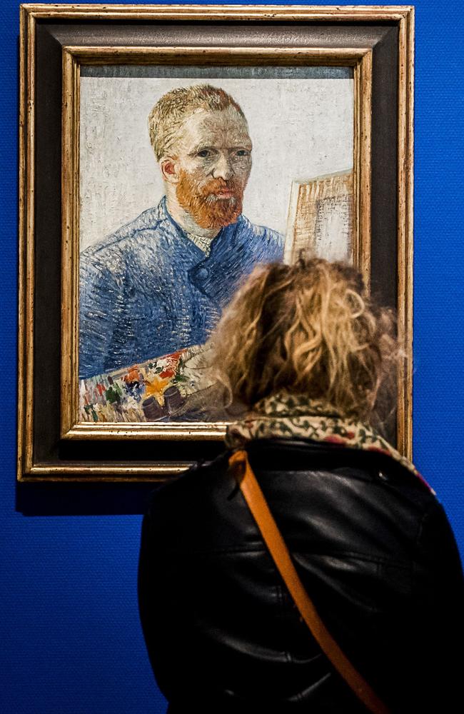 Visitors look at the painting ‘Self-portrait as a painter’ by Dutch artist Vincent van Gogh at the Van Gogh Museum in Amsterdam. Picture: AFP/ANP/Remko de Waal